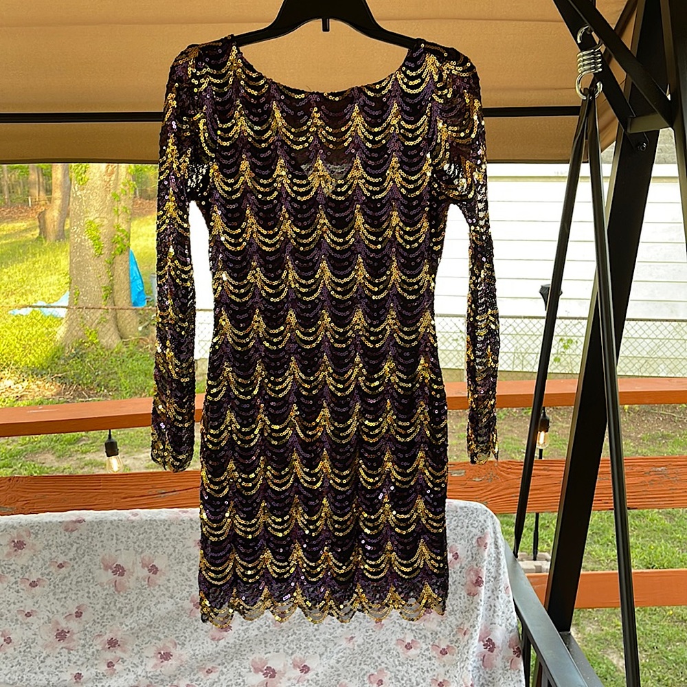 Black dress with gold and purple sequins. Long sleeves.
